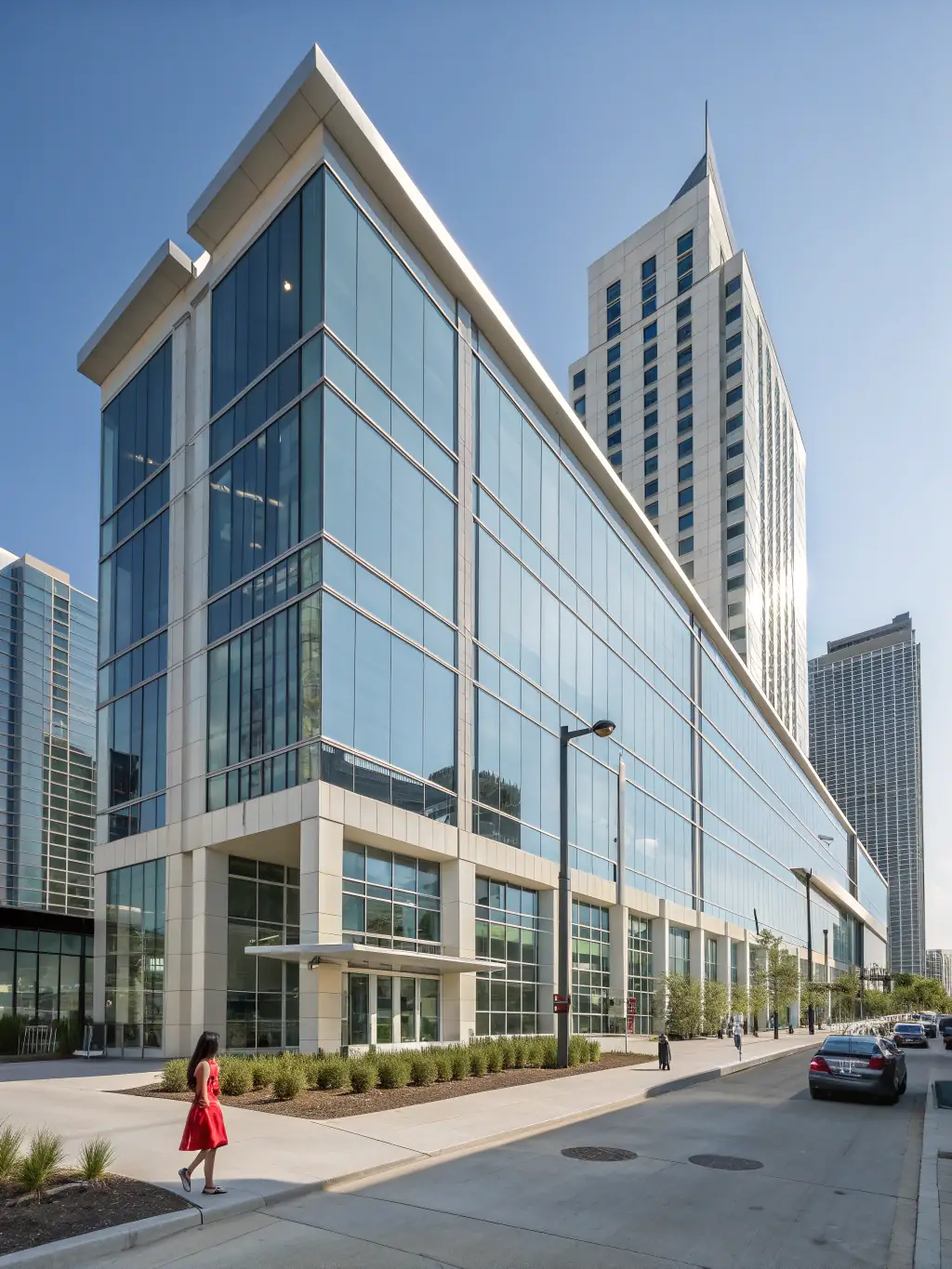 An exterior shot of a newly renovated commercial office building, highlighting modern architectural design, energy-efficient windows, and updated landscaping.